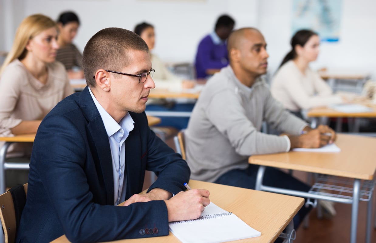 Focused man studying at adult education class